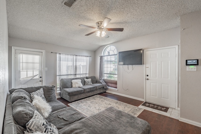 living room featuring a textured ceiling, ceiling fan, and hardwood / wood-style floors