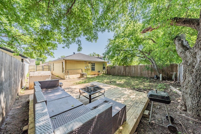 view of patio featuring a deck and an outdoor living space with a fire pit