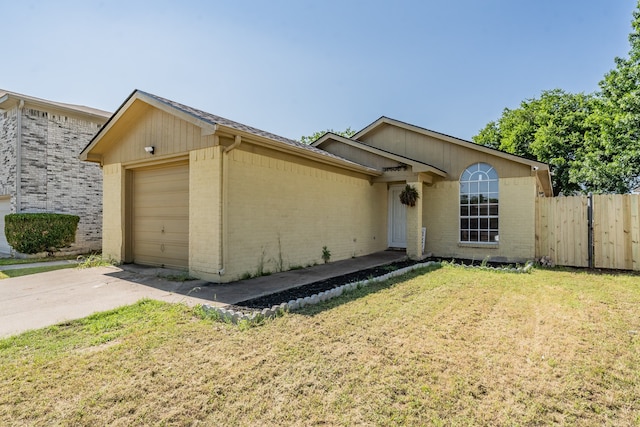 ranch-style house featuring a front lawn and a garage