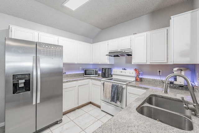 kitchen with light tile floors, sink, white cabinets, lofted ceiling, and appliances with stainless steel finishes