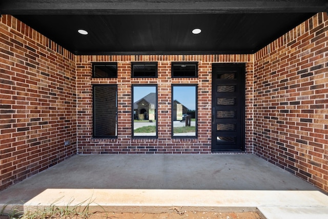 property entrance featuring brick siding