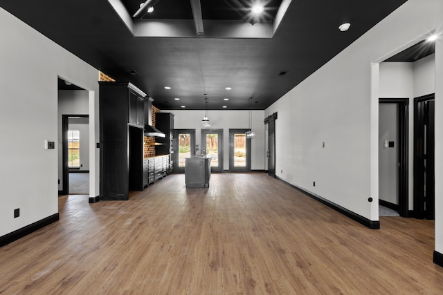 unfurnished living room with wood-type flooring and a wealth of natural light