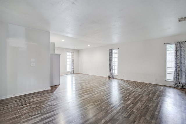 spare room with dark wood-type flooring