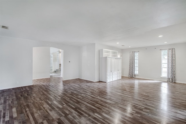 unfurnished living room featuring dark hardwood / wood-style flooring