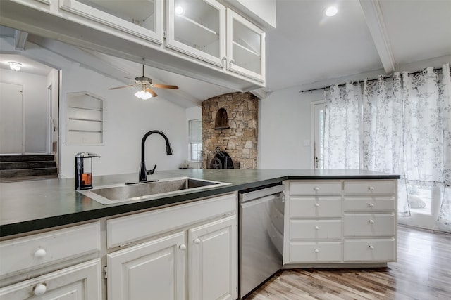 kitchen with beamed ceiling, sink, white cabinets, stainless steel dishwasher, and light hardwood / wood-style flooring