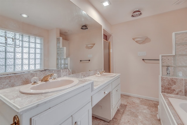 bathroom with vanity and a bathing tub