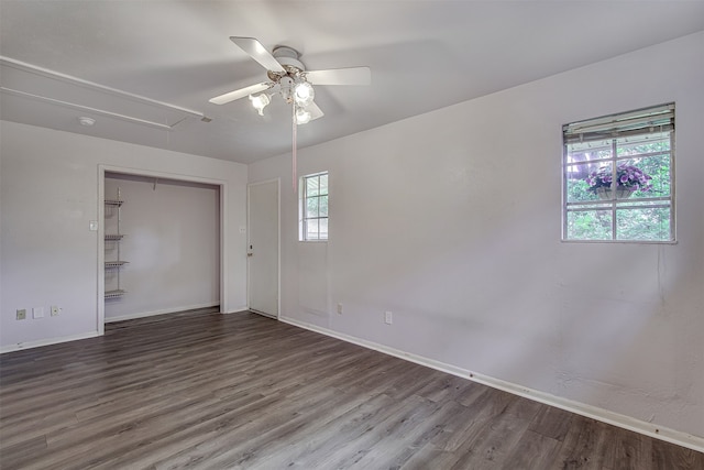 empty room with hardwood / wood-style floors and ceiling fan