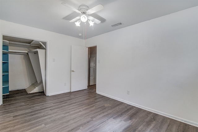 unfurnished bedroom featuring wood-type flooring, ceiling fan, and a closet