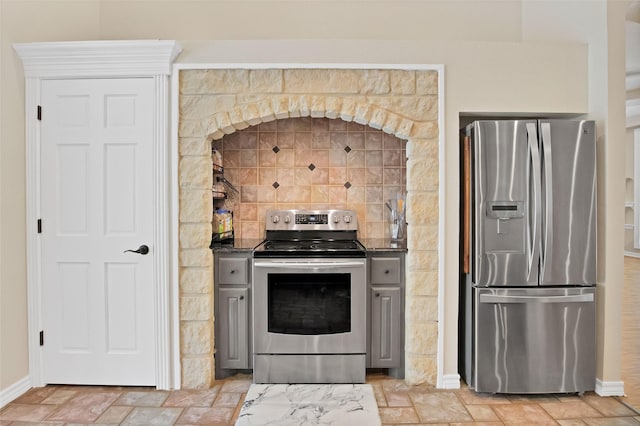 kitchen featuring gray cabinetry, decorative backsplash, and appliances with stainless steel finishes