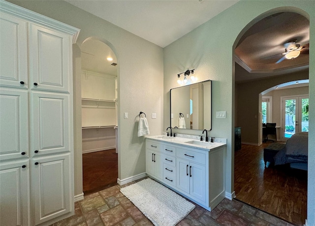 bathroom with french doors, hardwood / wood-style floors, vanity, and ceiling fan