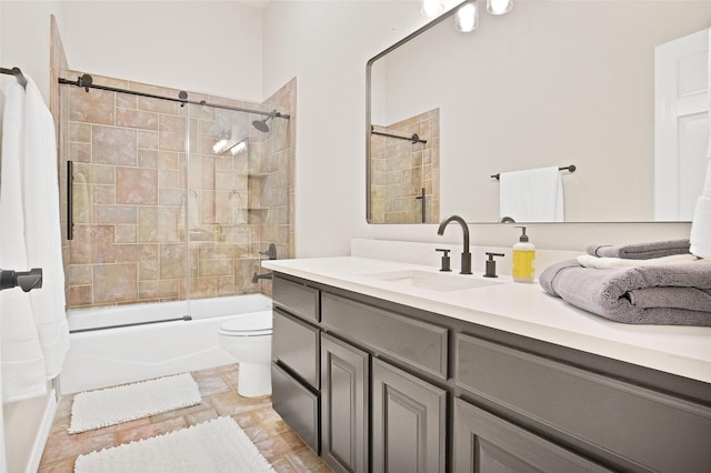 full bathroom featuring vanity, enclosed tub / shower combo, and toilet