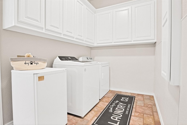 laundry room with washing machine and clothes dryer and cabinets