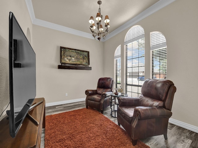 sitting room featuring an inviting chandelier, crown molding, and hardwood / wood-style flooring