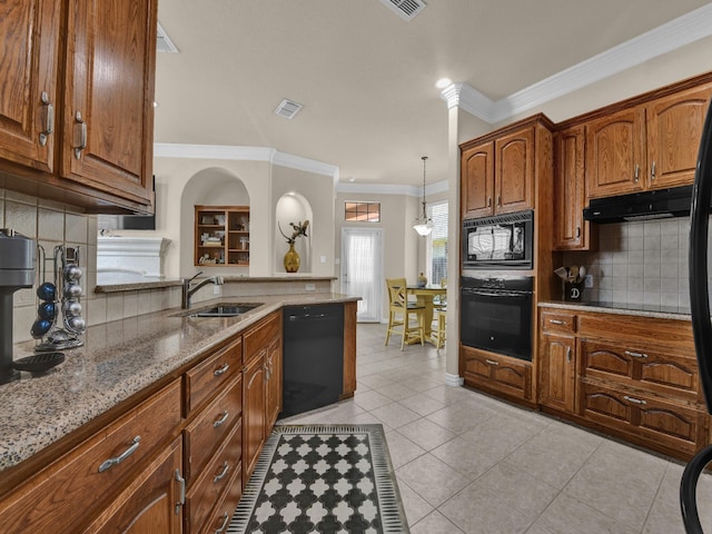 kitchen featuring sink, light stone counters, decorative light fixtures, light tile patterned floors, and black appliances