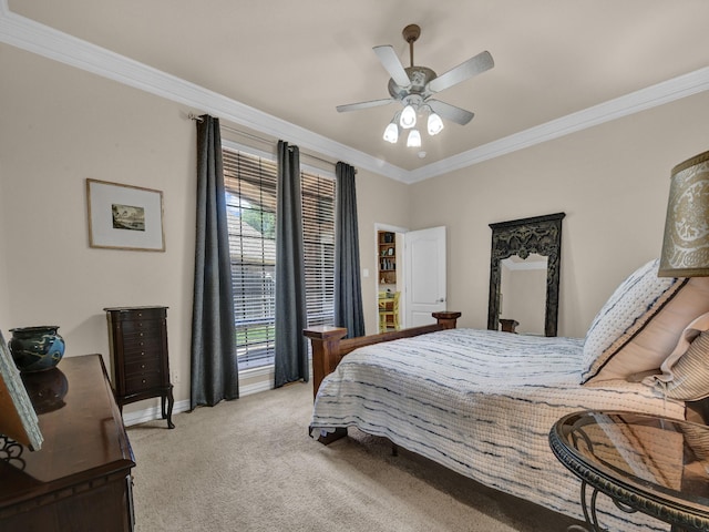 carpeted bedroom with ornamental molding and ceiling fan