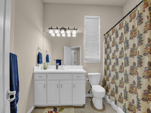 bathroom with vanity, walk in shower, tile patterned floors, and toilet