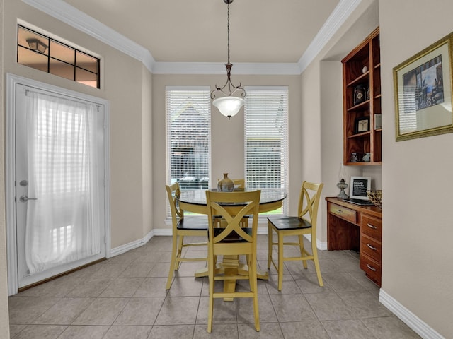 dining area featuring built in desk, ornamental molding, and light tile patterned flooring