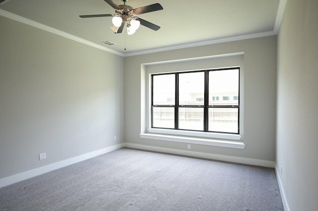 carpeted spare room featuring ornamental molding and ceiling fan