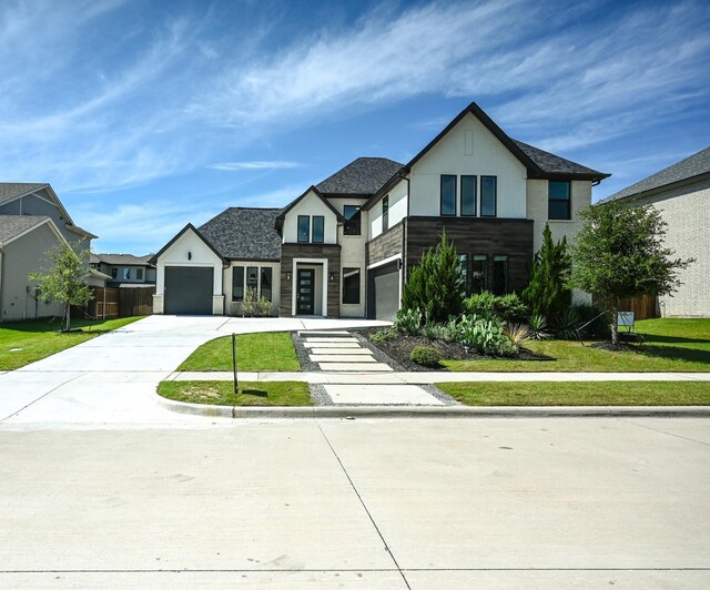 view of front facade with a garage and a front lawn