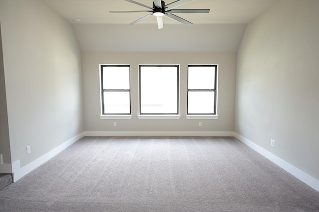 unfurnished room with ceiling fan, lofted ceiling, light colored carpet, and a wealth of natural light