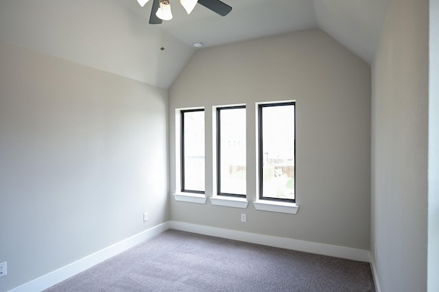 spare room with lofted ceiling, carpet floors, and ceiling fan