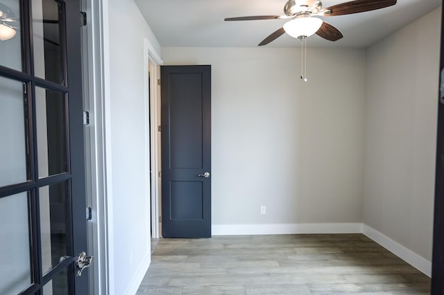 empty room featuring ceiling fan and light hardwood / wood-style floors