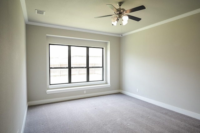 carpeted spare room featuring ornamental molding and ceiling fan