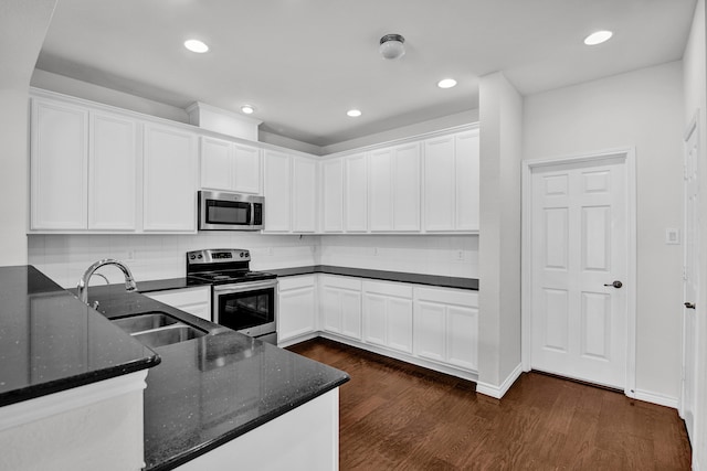 kitchen with appliances with stainless steel finishes, dark hardwood / wood-style flooring, sink, and tasteful backsplash