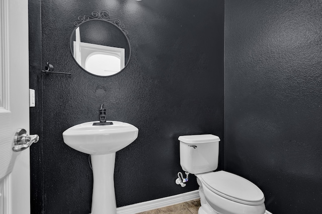 bathroom featuring tile patterned flooring and toilet