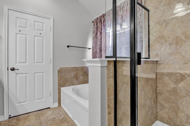 bathroom featuring tile patterned flooring and independent shower and bath