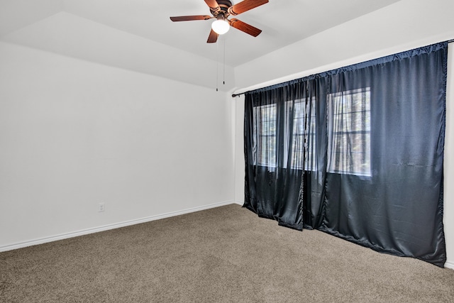 carpeted spare room with ceiling fan and lofted ceiling