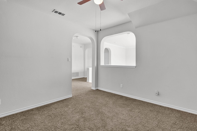 spare room featuring ceiling fan and carpet floors