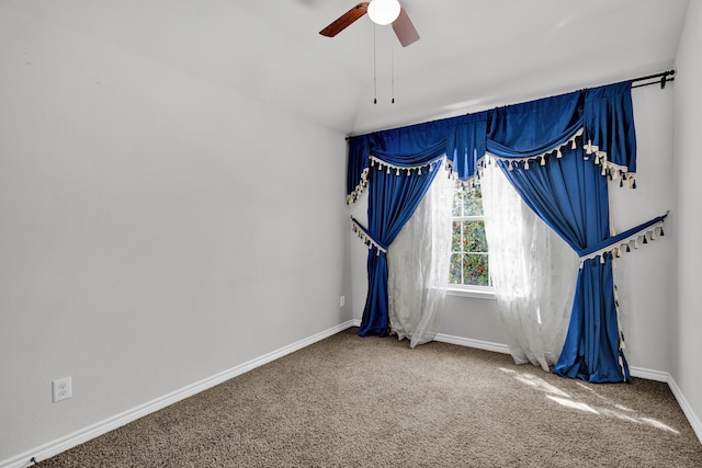 carpeted empty room with ceiling fan and lofted ceiling