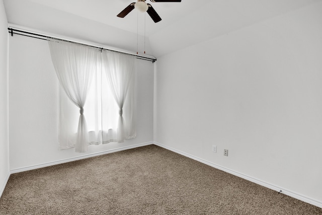 carpeted empty room featuring ceiling fan and vaulted ceiling