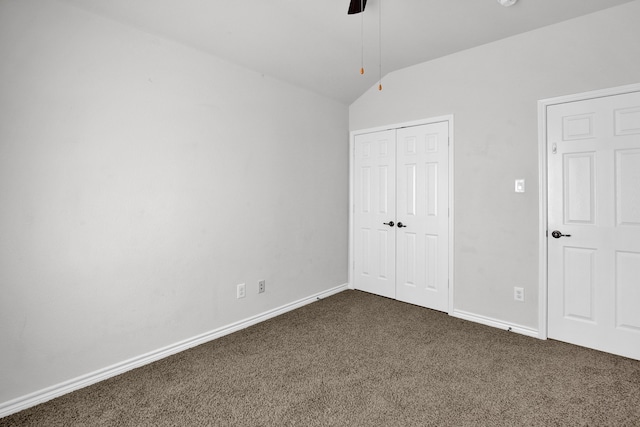 unfurnished bedroom with ceiling fan, carpet flooring, and lofted ceiling