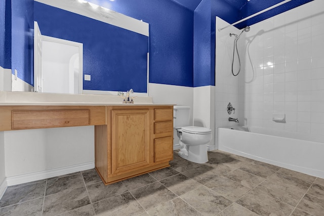 full bathroom with tile patterned flooring, tiled shower / bath, toilet, and vanity