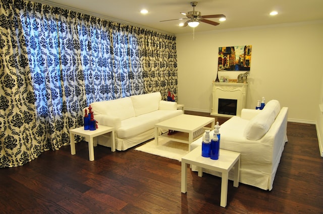 living room with hardwood / wood-style flooring, crown molding, and ceiling fan