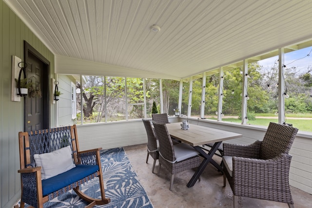 sunroom / solarium with lofted ceiling and a wealth of natural light