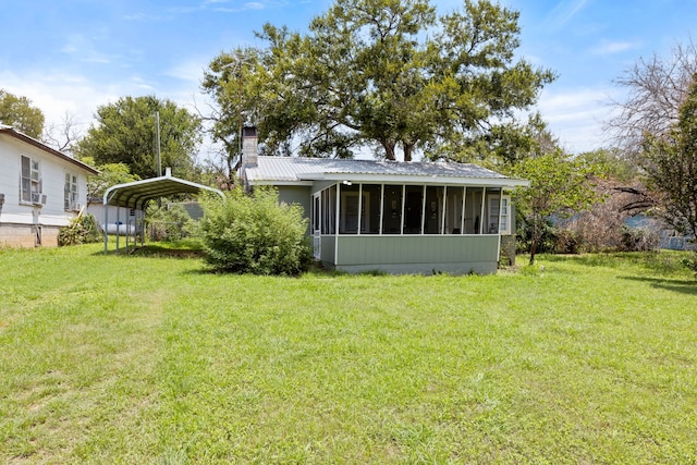 view of yard with a carport and a sunroom