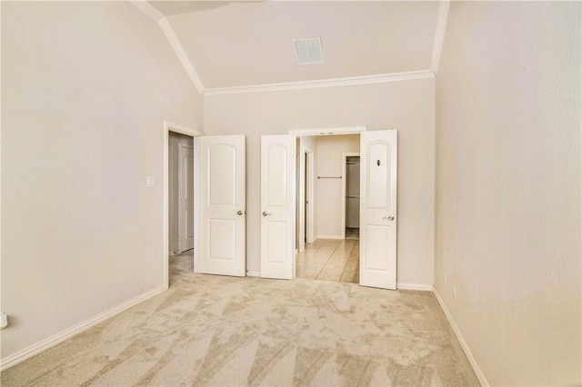 unfurnished bedroom featuring crown molding, light carpet, and high vaulted ceiling