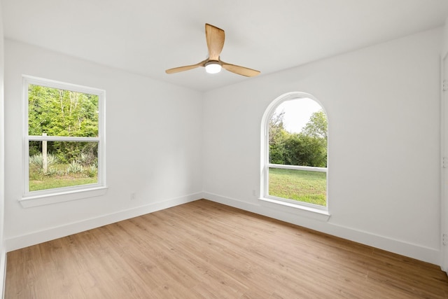 empty room with ceiling fan and light wood-type flooring