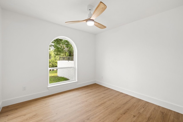 unfurnished room with light wood-type flooring, a wealth of natural light, and ceiling fan