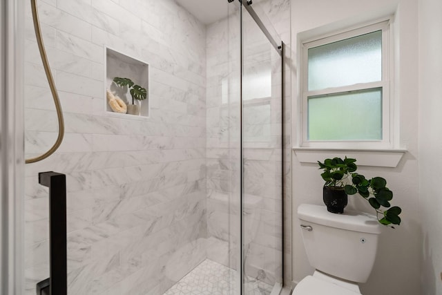 bathroom featuring toilet and an enclosed shower