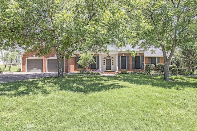 view of front of home with a garage and a front yard