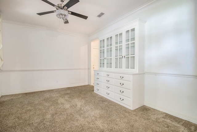 spare room with hardwood / wood-style flooring, ceiling fan, and crown molding