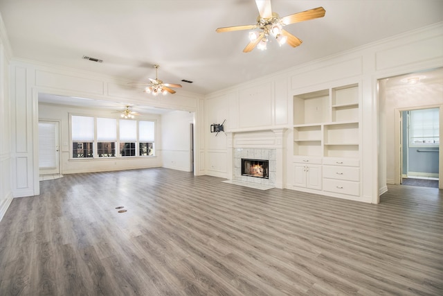 unfurnished living room with light hardwood / wood-style floors, ceiling fan, and ornamental molding