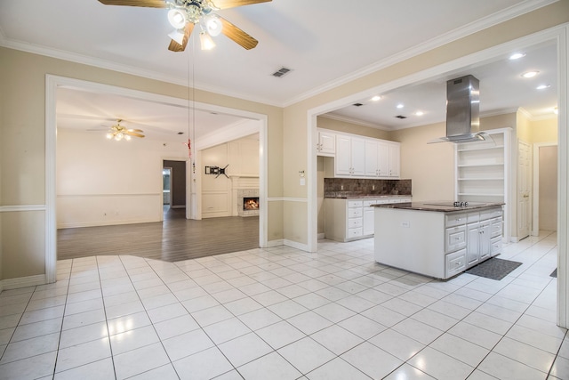 unfurnished living room featuring hardwood / wood-style floors, ceiling fan, and ornamental molding