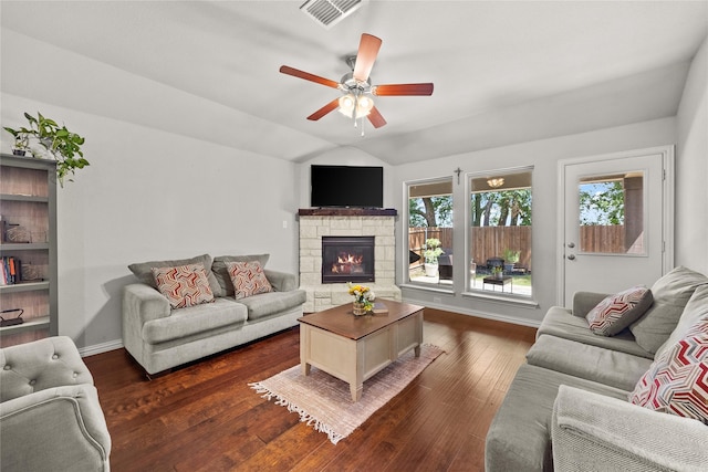 living room featuring ceiling fan, dark hardwood / wood-style floors, lofted ceiling, and a fireplace