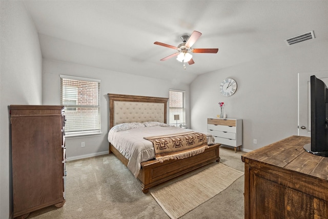 carpeted bedroom featuring ceiling fan, multiple windows, and vaulted ceiling