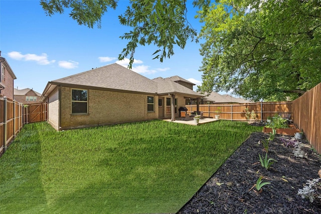 rear view of house featuring a patio area and a yard